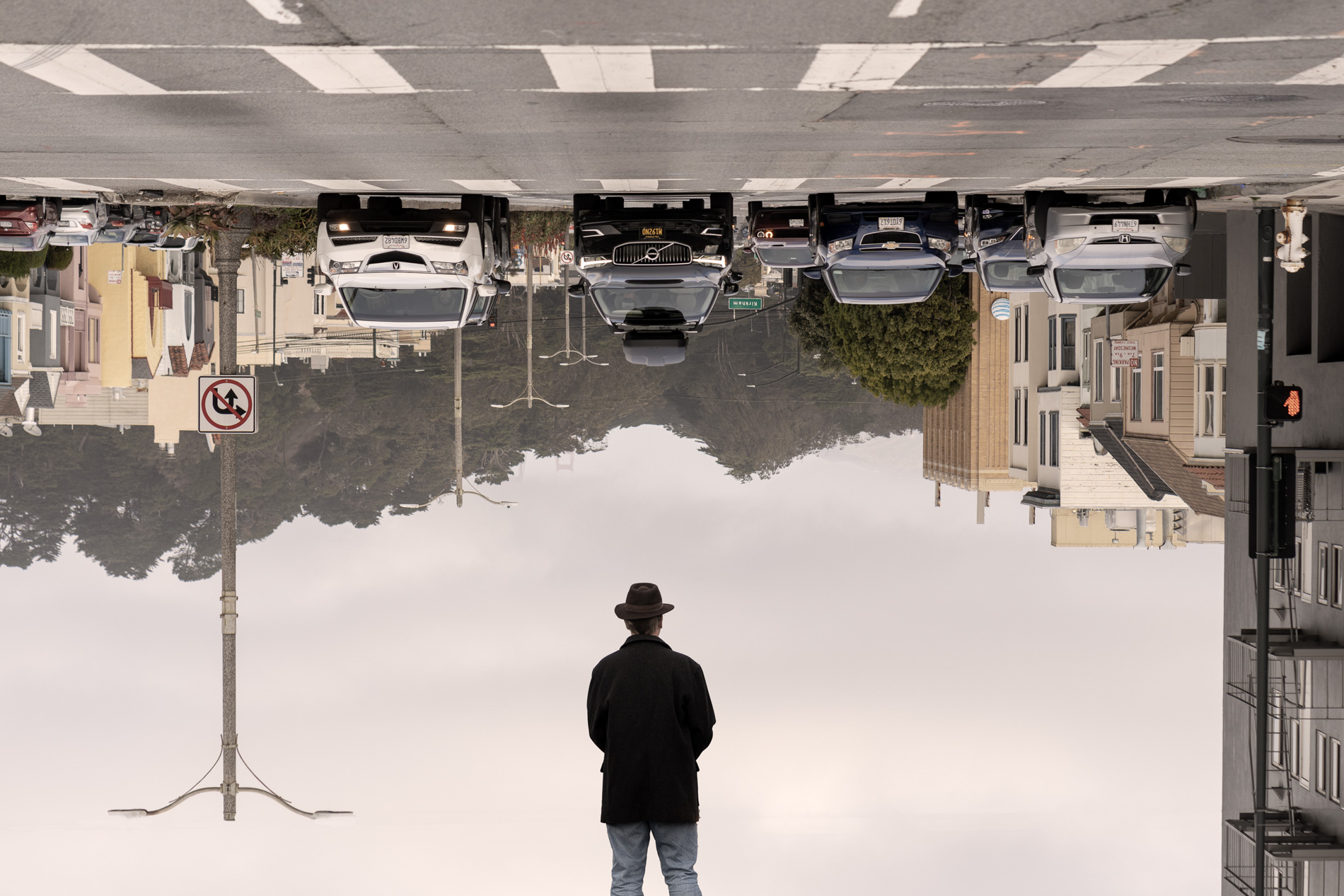 man in front of upside down city
