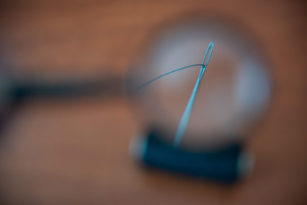 magnified view of an aqua sewing needle