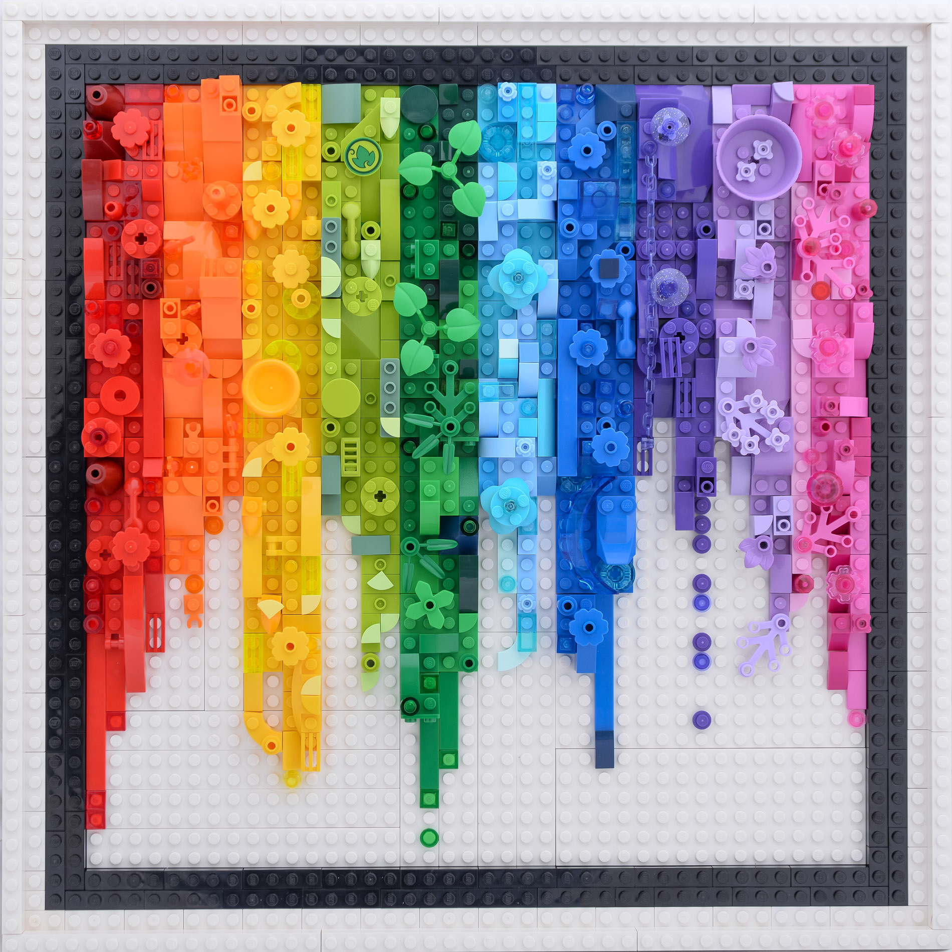 cascading Lego bricks in rainbow order. White Lego background, with a black border